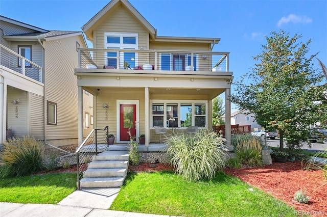 view of front of house with a balcony and covered porch