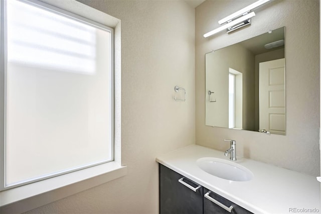 bathroom featuring plenty of natural light and vanity