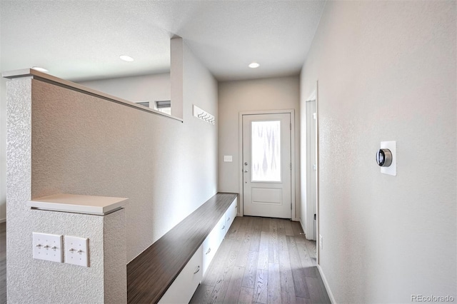 entryway with dark hardwood / wood-style flooring