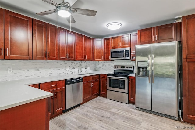 595 S Alton Way Unit 7B, Denver, CO 80247 - kitchen featuring appliances with stainless steel finishes, decorative backsplash, reddish brown cabinets, and a ceiling fan