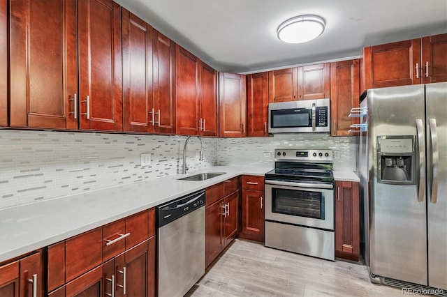 595 S Alton Way Unit 7B, Denver, CO 80247 - kitchen with stainless steel appliances, light countertops, light wood-type flooring, and tasteful backsplash