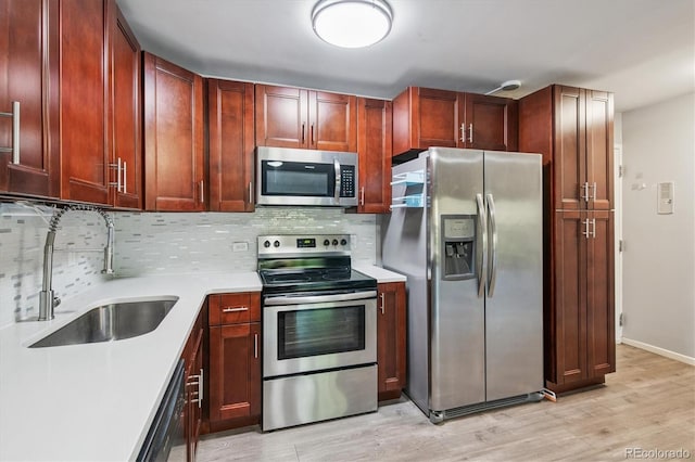 595 S Alton Way Unit 7B, Denver, CO 80247 - kitchen with appliances with stainless steel finishes, light countertops, decorative backsplash, light wood-style flooring, and dark brown cabinets