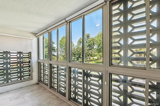 595 S Alton Way Unit 7B, Denver, CO 80247 - unfurnished sunroom featuring a textured ceiling