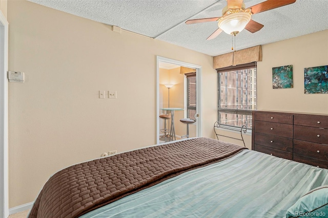 bedroom featuring ceiling fan and a textured ceiling