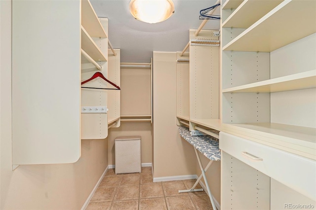 spacious closet with light tile patterned floors