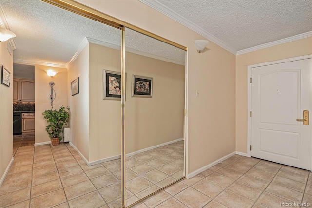 entryway featuring light tile patterned flooring, ornamental molding, and a textured ceiling