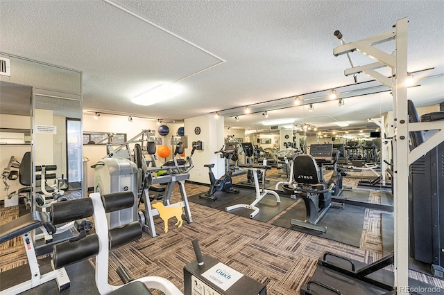 exercise room with a textured ceiling