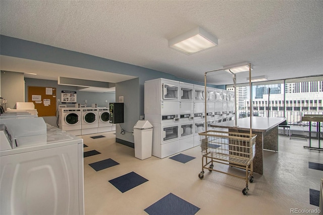 clothes washing area with stacked washer and clothes dryer, a textured ceiling, and washer and dryer