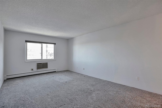 carpeted spare room with a textured ceiling and baseboard heating