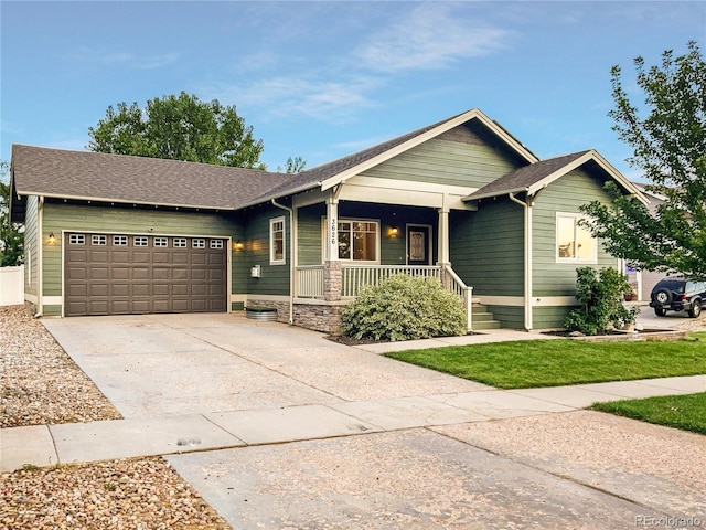 view of front of home featuring covered porch and a garage