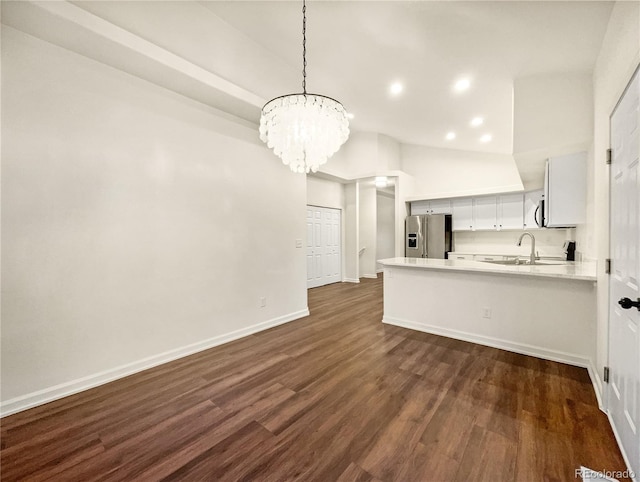 kitchen with stainless steel fridge with ice dispenser, dark wood-type flooring, kitchen peninsula, a chandelier, and white cabinets