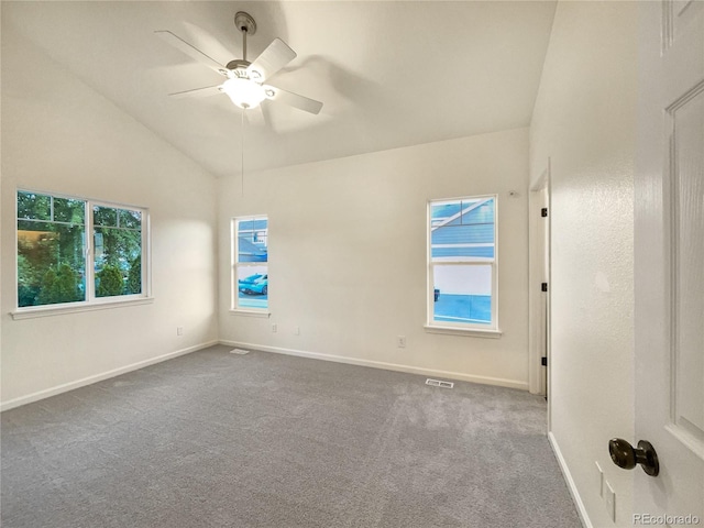 spare room with vaulted ceiling, ceiling fan, and carpet floors