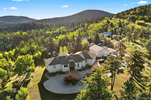 aerial view featuring a forest view and a mountain view