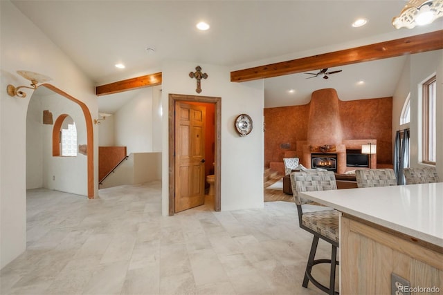 kitchen with beamed ceiling, recessed lighting, light countertops, and ceiling fan