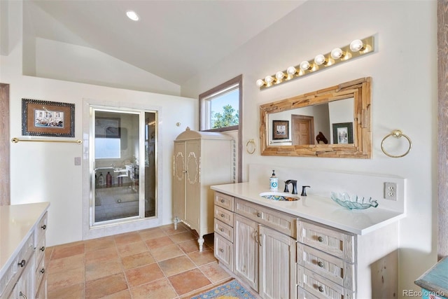 bathroom with vanity and lofted ceiling