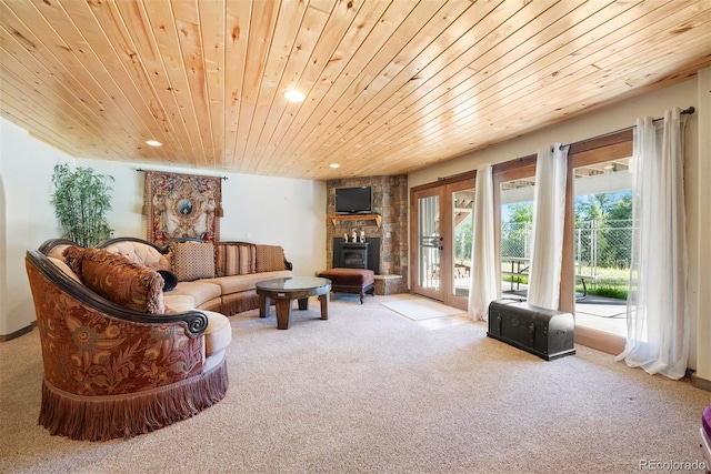 carpeted living room featuring french doors, a fireplace, recessed lighting, and wood ceiling