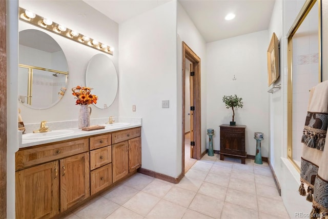 full bath featuring a sink, double vanity, baseboards, and a shower stall