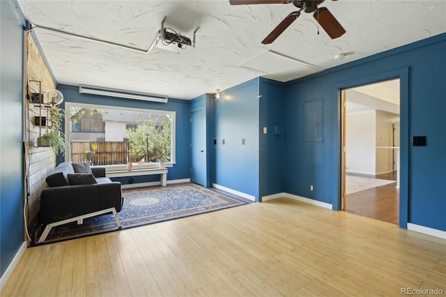 foyer featuring ceiling fan, wood finished floors, and baseboards