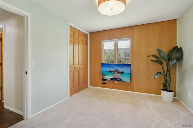 unfurnished bedroom with carpet flooring, a closet, and baseboards