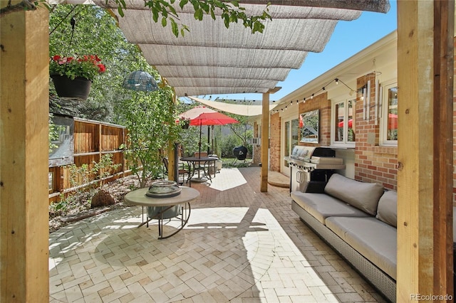view of patio / terrace with a grill, outdoor lounge area, outdoor dining space, and fence