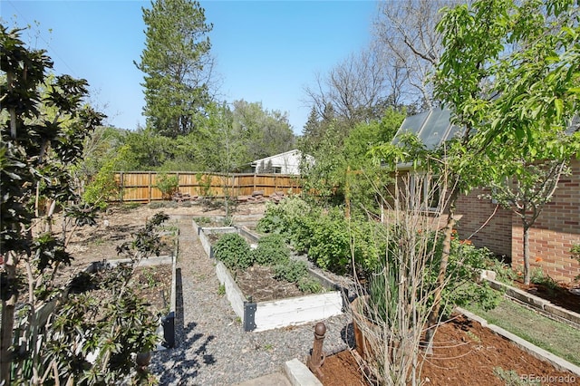 view of yard with a garden and fence