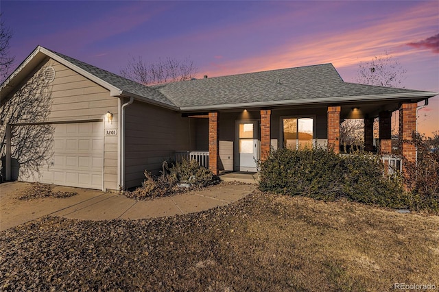 ranch-style house with a porch and a garage