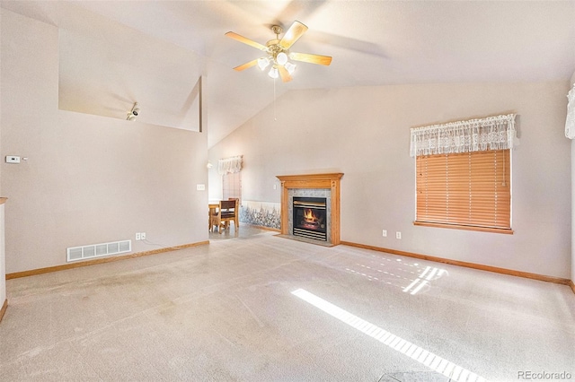 unfurnished living room featuring a high end fireplace, ceiling fan, carpet, and vaulted ceiling