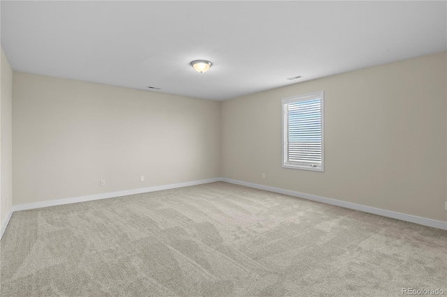 unfurnished room with light colored carpet