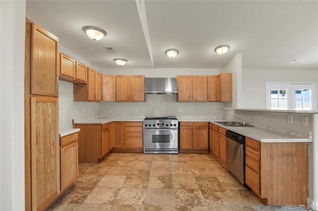 kitchen featuring appliances with stainless steel finishes, wall chimney exhaust hood, and sink