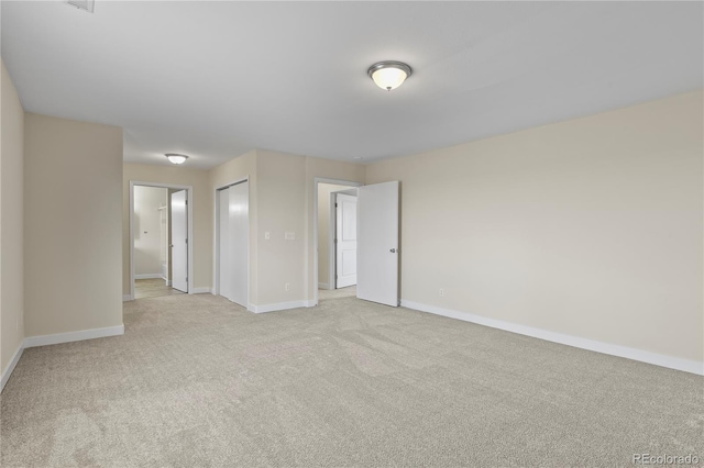 spare room featuring light colored carpet