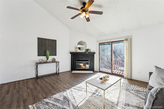 6447 Jonathan Ct, Colorado Springs, CO 80918 - living room with lofted ceiling, a textured ceiling, a fireplace with flush hearth, ceiling fan, and wood finished floors