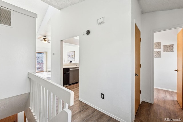6447 Jonathan Ct, Colorado Springs, CO 80918 - hall with visible vents, baseboards, an upstairs landing, and wood finished floors