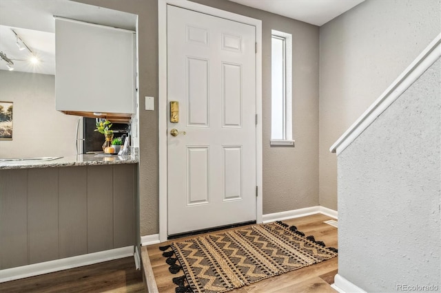 2491 S Xanadu Way Unit A, Aurora, CO 80014 - entryway with wood finished floors, baseboards, and rail lighting