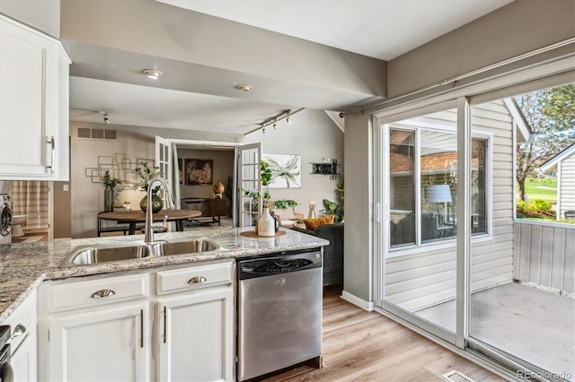 2491 S Xanadu Way Unit A, Aurora, CO 80014 - kitchen with dishwasher, a sink, a peninsula, and plenty of natural light