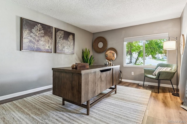 2491 S Xanadu Way Unit A, Aurora, CO 80014 - office area featuring wood finished floors, a textured ceiling, and baseboards