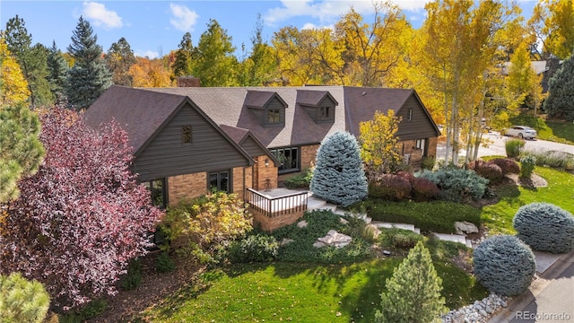 view of front of house with a front yard and a deck