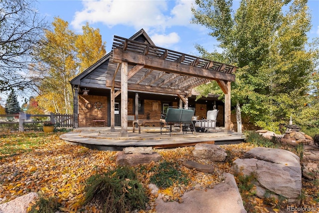 back of house with a deck and a pergola