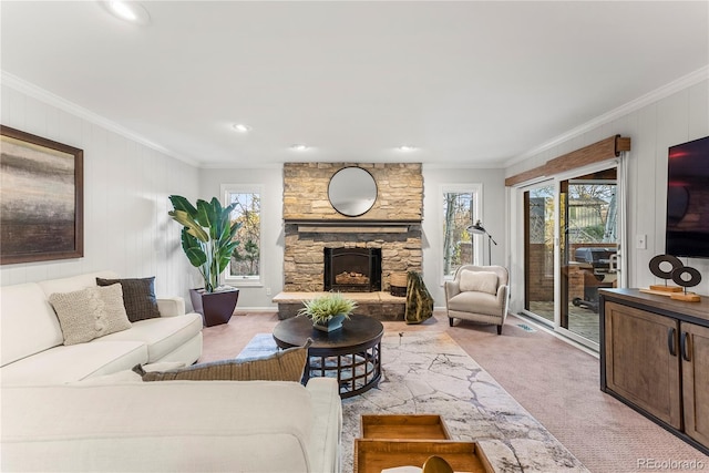 living room with ornamental molding, light carpet, and a fireplace