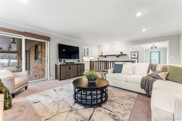 living room with crown molding and light carpet