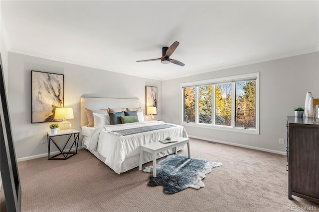 bedroom with ceiling fan, ornamental molding, and carpet