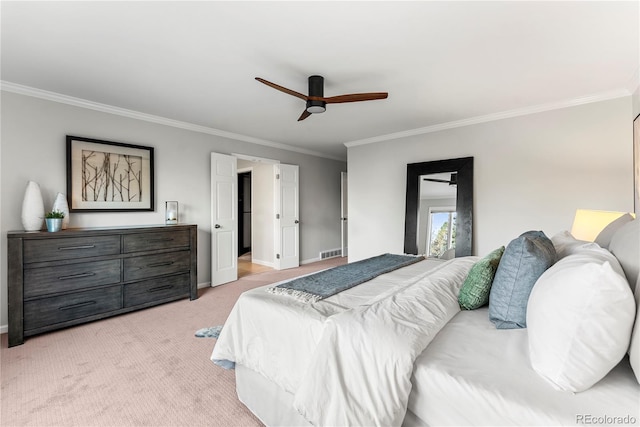 carpeted bedroom with ceiling fan and crown molding