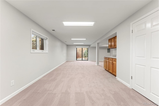 unfurnished living room featuring light colored carpet