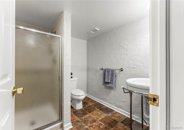 bathroom featuring toilet and walk in shower