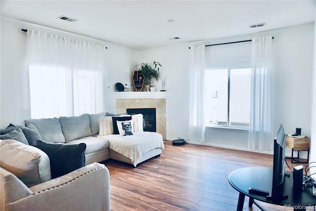 14700 E 104th Ave Unit 2605, Commerce City, CO 80022 - living room with a fireplace, wood finished floors, and baseboards