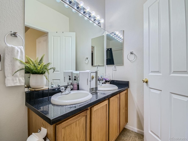 14700 E 104th Ave Unit 2605, Commerce City, CO 80022 - full bath with double vanity, tile patterned flooring, and baseboards