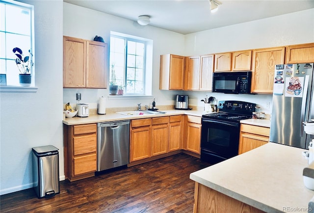 14700 E 104th Ave Unit 2605, Commerce City, CO 80022 - kitchen with black appliances, a sink, dark wood-type flooring, and light countertops
