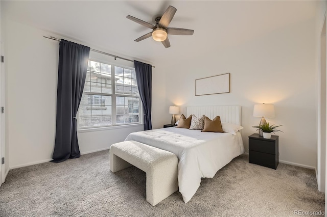 bedroom featuring light carpet, baseboards, and ceiling fan