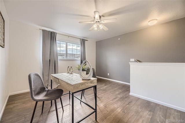 office area with wood finished floors, ceiling fan, and baseboards