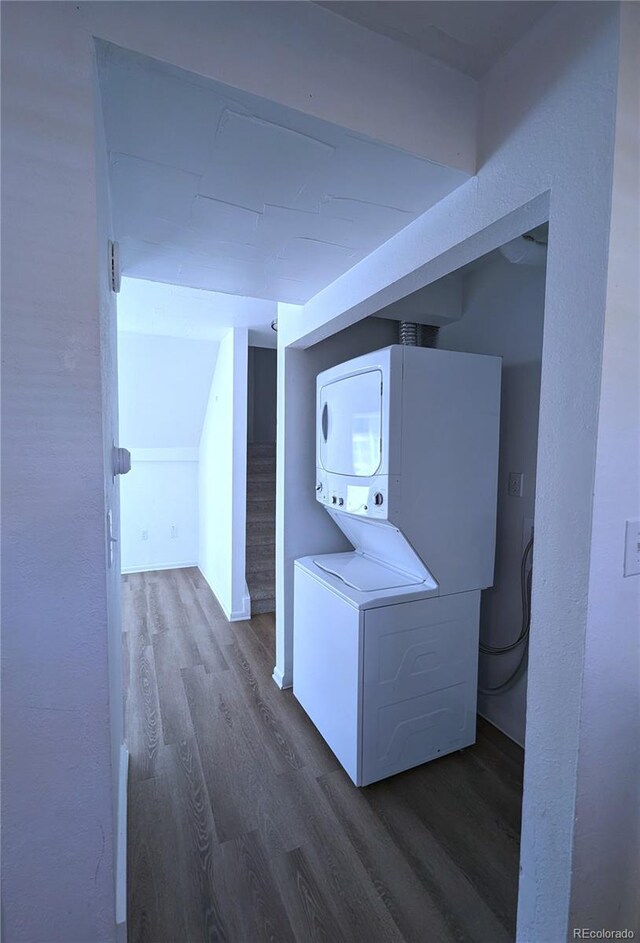 921 Mt Massive Dr Unit 25, Leadville, CO 80461 - washroom featuring stacked washing machine and dryer and dark wood-style floors