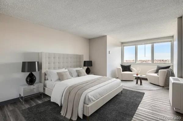 2225 Buchtel Blvd Unit 1003, Denver, CO 80210 - bedroom featuring a textured ceiling and wood finished floors